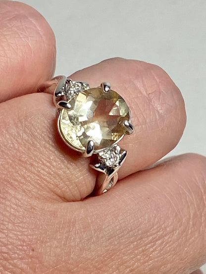 Sterling silver ring with oval Oregon sunstone and two diamonds.