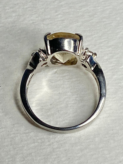 Sterling silver ring with an oval Oregon sunstone and two diamonds.