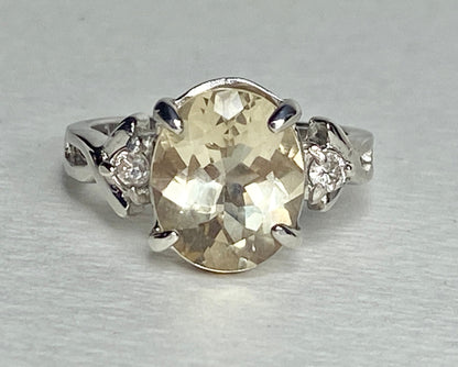 Sterling silver ring with oval Oregon sunstone and two round diamonds.