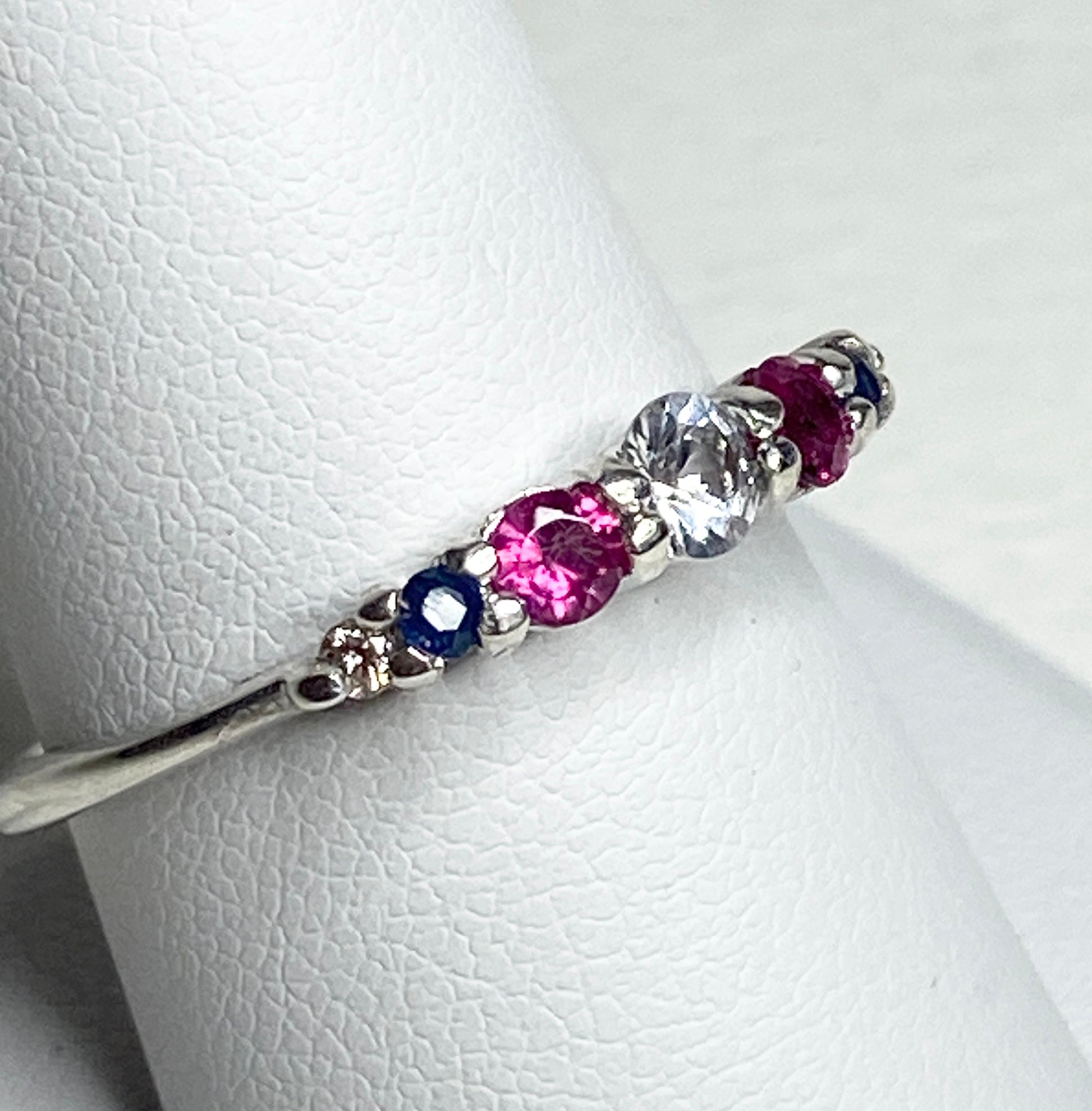Sterling silver ring with sapphire, ruby, and diamond accents.