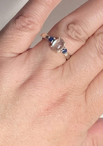 Sterling silver ring with oval labradorite and two blue sapphires.