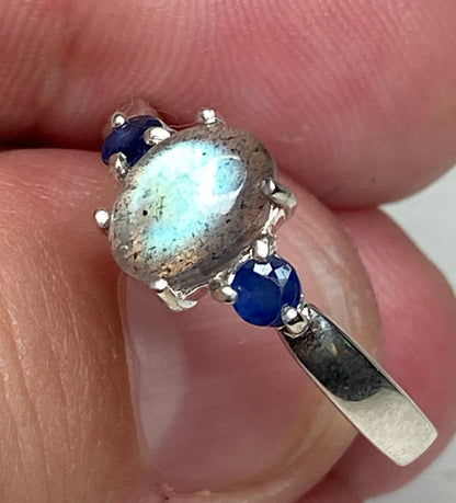 Sterling silver ring with oval labradorite and two round blue sapphires.