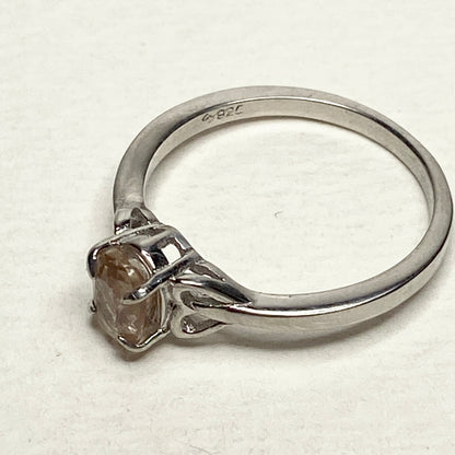Sterling silver ring with a light peach oval sunstone.