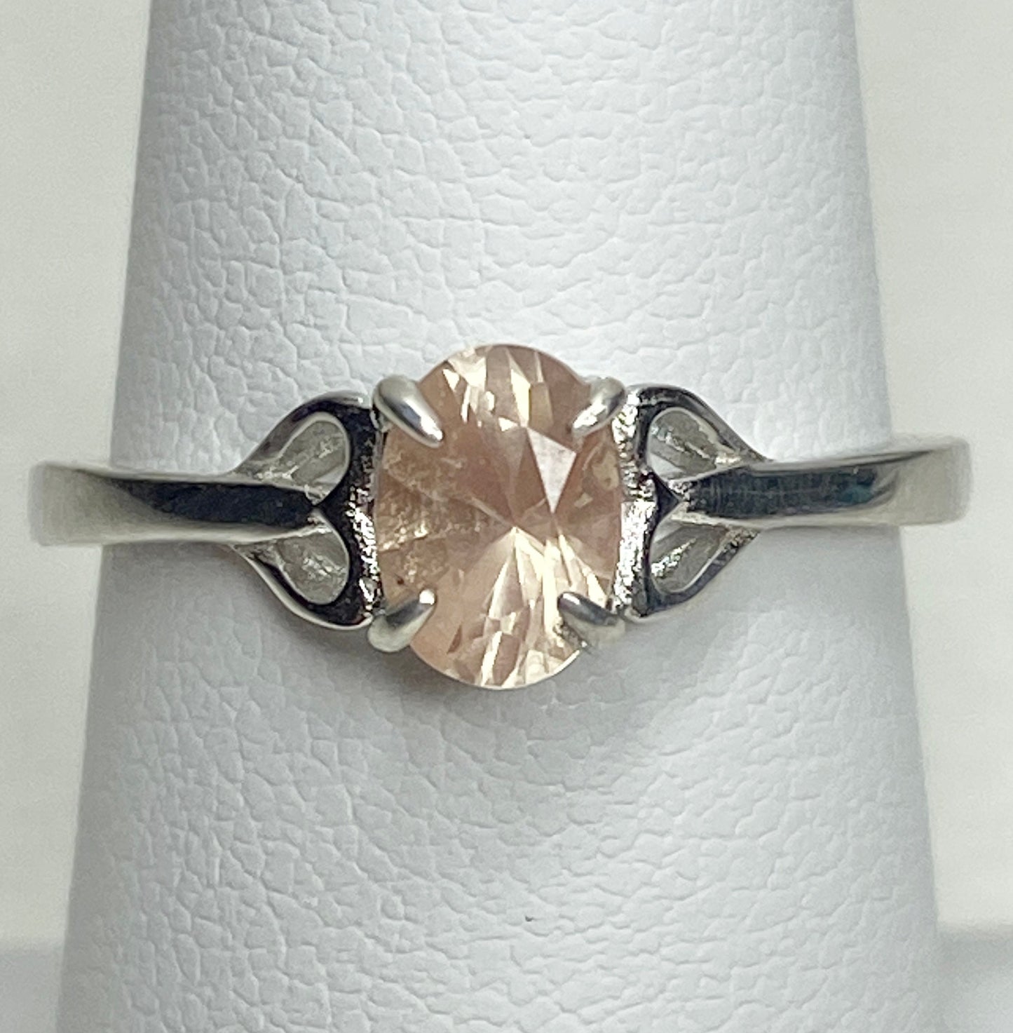 Sterling silver ring with a light peach oval Oregon sunstone and heart-shaped accents.
