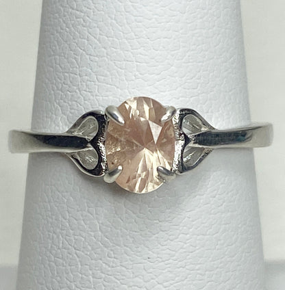 Sterling silver ring with a light peach oval Oregon sunstone and heart-shaped accents.