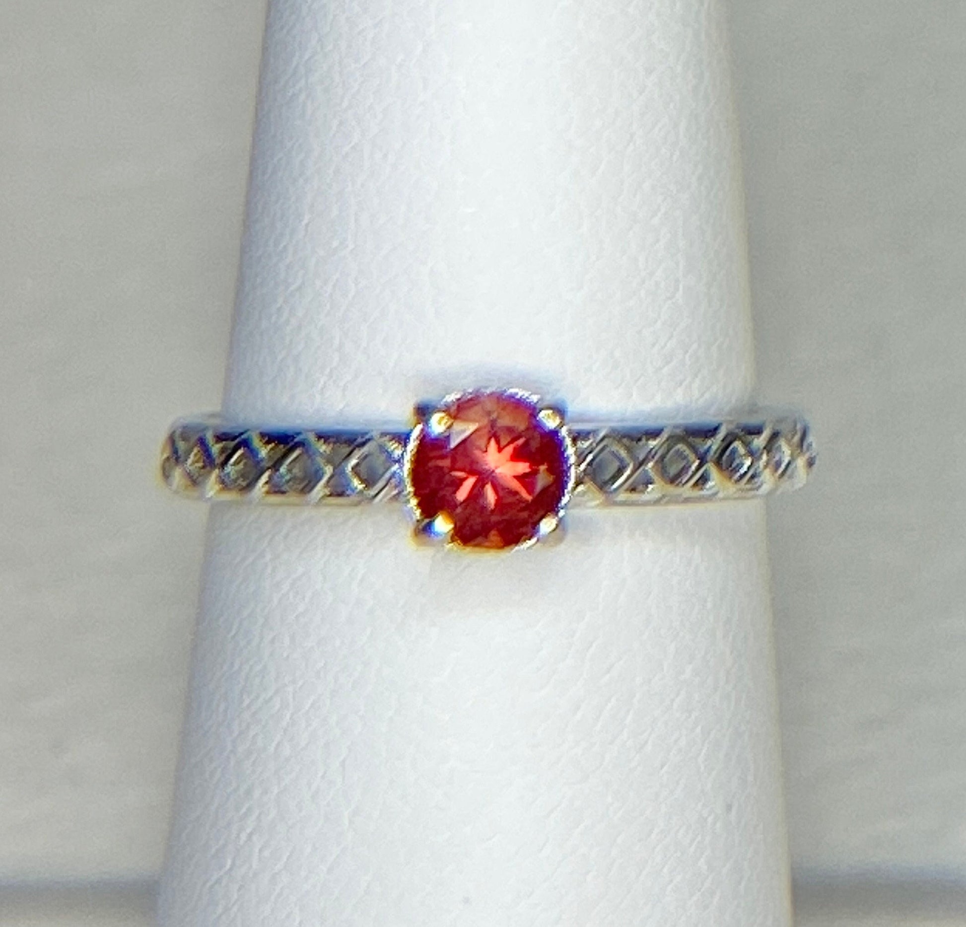 Sterling silver ring with a light red Oregon sunstone and diamond trellis design.