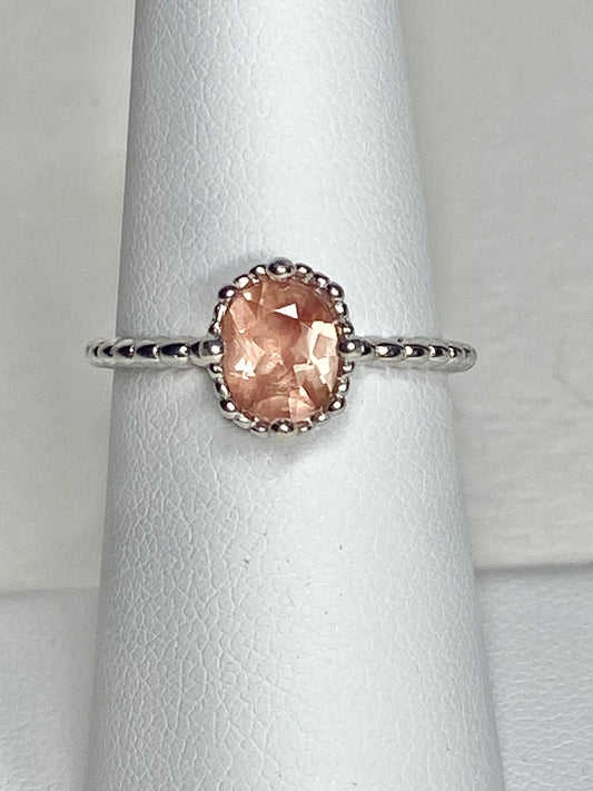 Sterling silver ring with a peach oval Oregon Sunstone in a beaded setting.