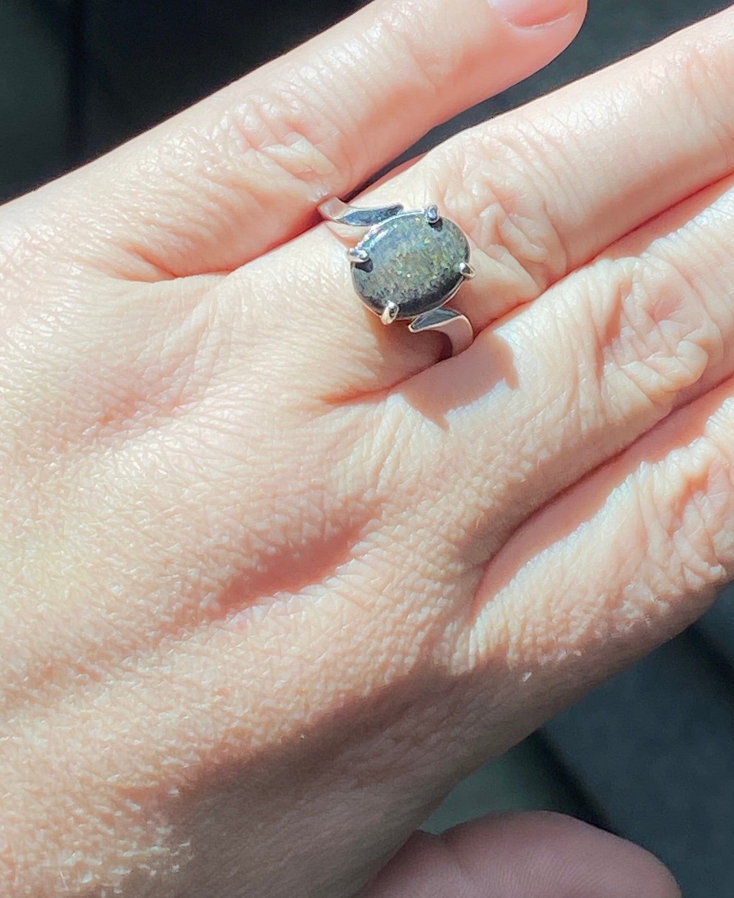 Sterling silver ring with an oval pinfire boulder opal.
