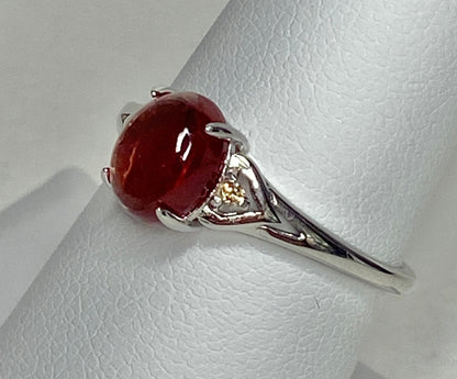 Sterling silver ring with a red Oregon sunstone and natural diamonds.