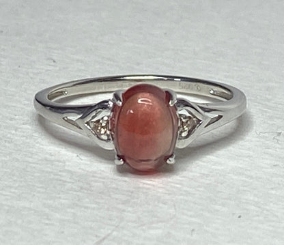 Sterling silver ring with oval red sunstone and small diamonds.