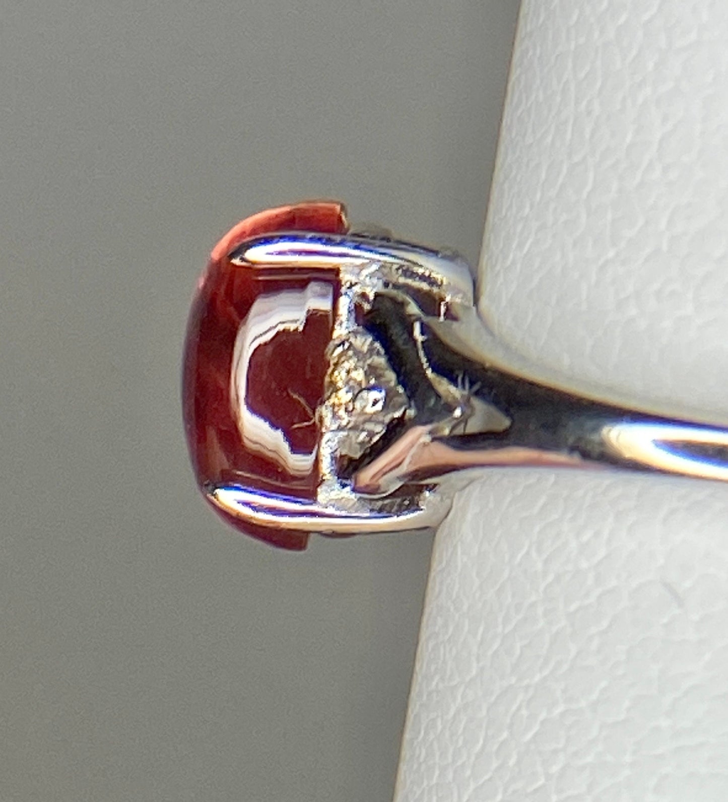 Sterling silver ring with a red Oregon sunstone and natural diamonds.