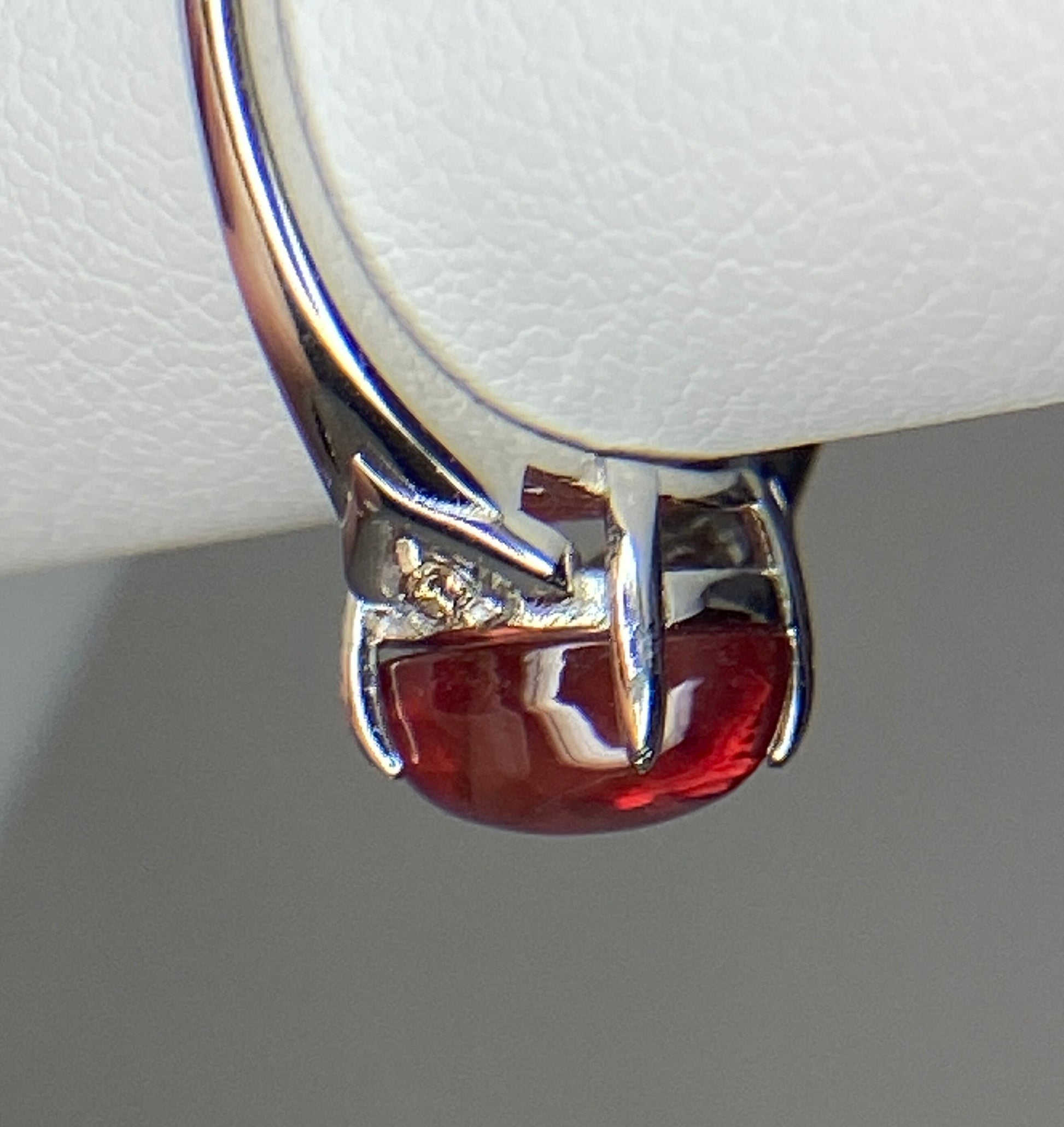 Sterling silver ring with a red Oregon sunstone and natural diamonds.