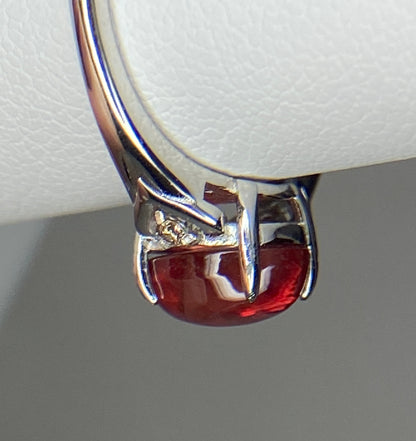 Sterling silver ring with a red Oregon sunstone and natural diamonds.