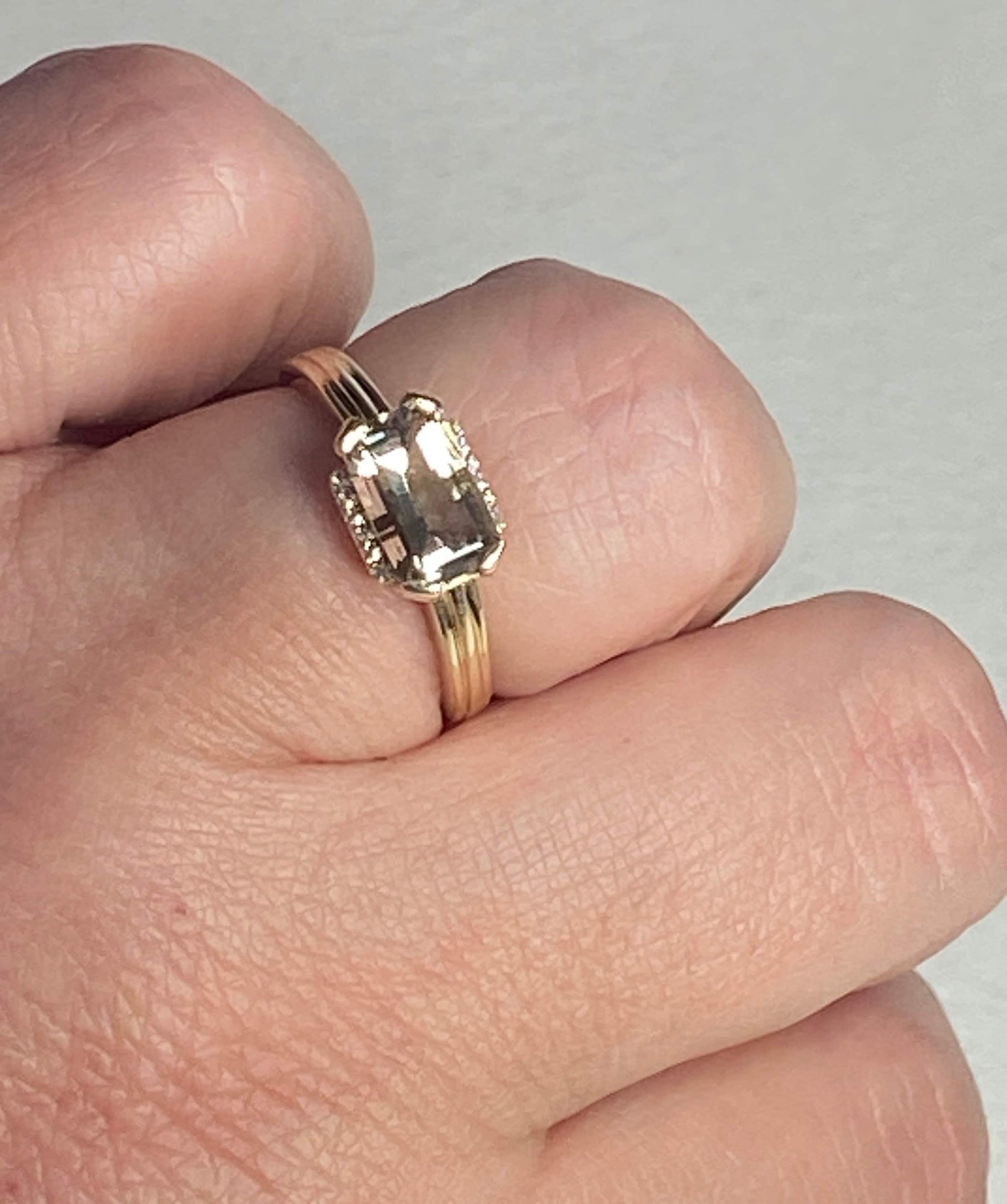 A light green Oregon Sunstone and diamond ring in 10k yellow gold.