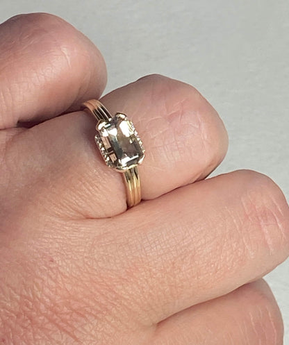 A light green Oregon Sunstone and diamond ring in 10k yellow gold.