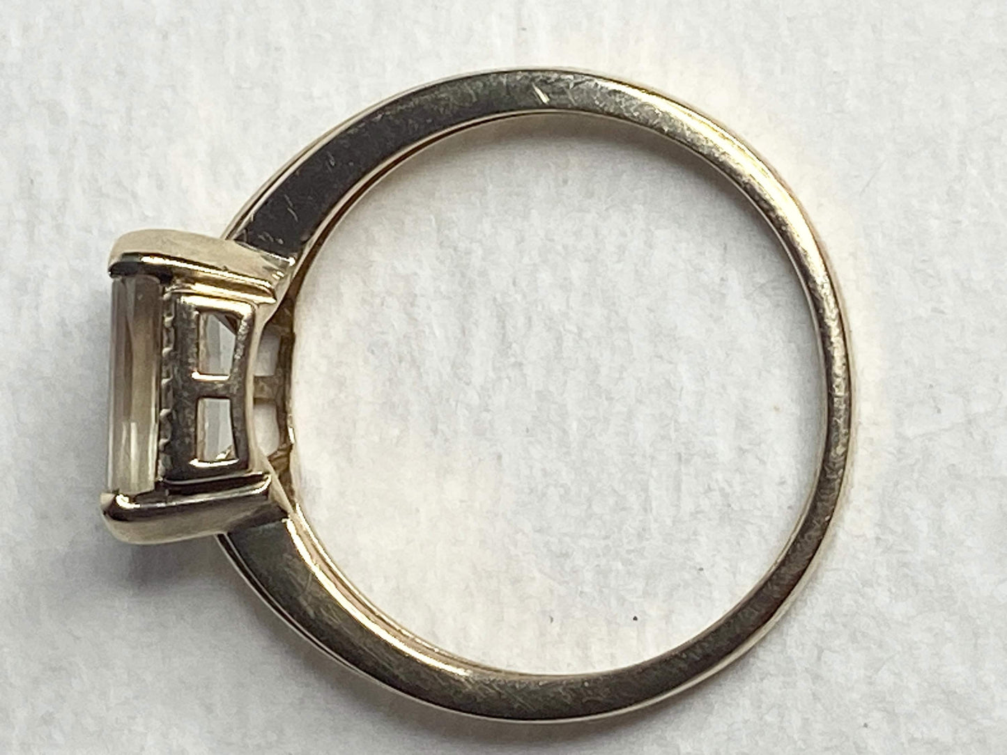 A 10k yellow gold ring with a light green Oregon Sunstone and diamonds.