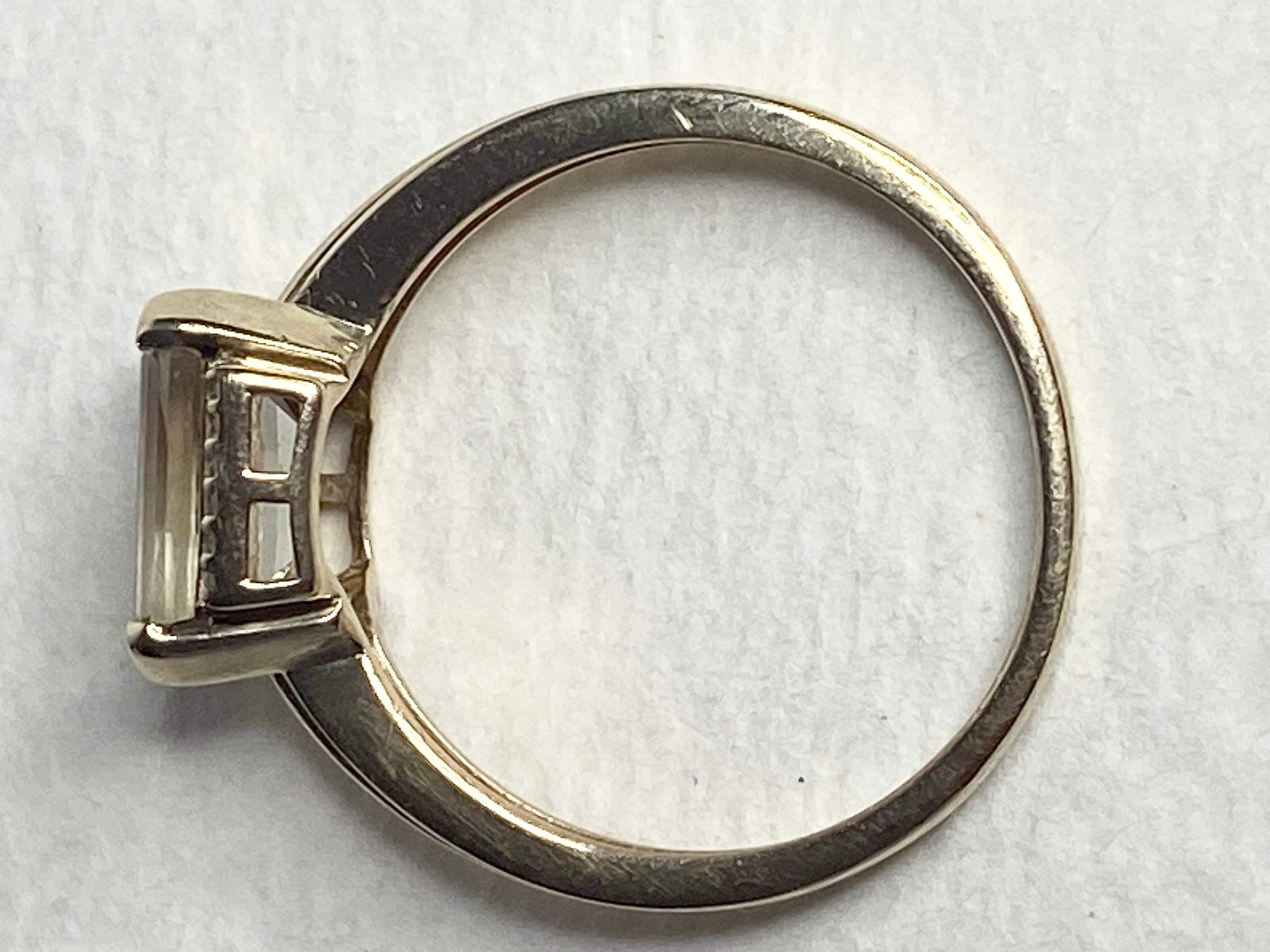 A 10k yellow gold ring with a light green Oregon Sunstone and diamonds.