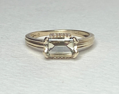 A 10k yellow gold ring with a light green Oregon Sunstone and diamonds.