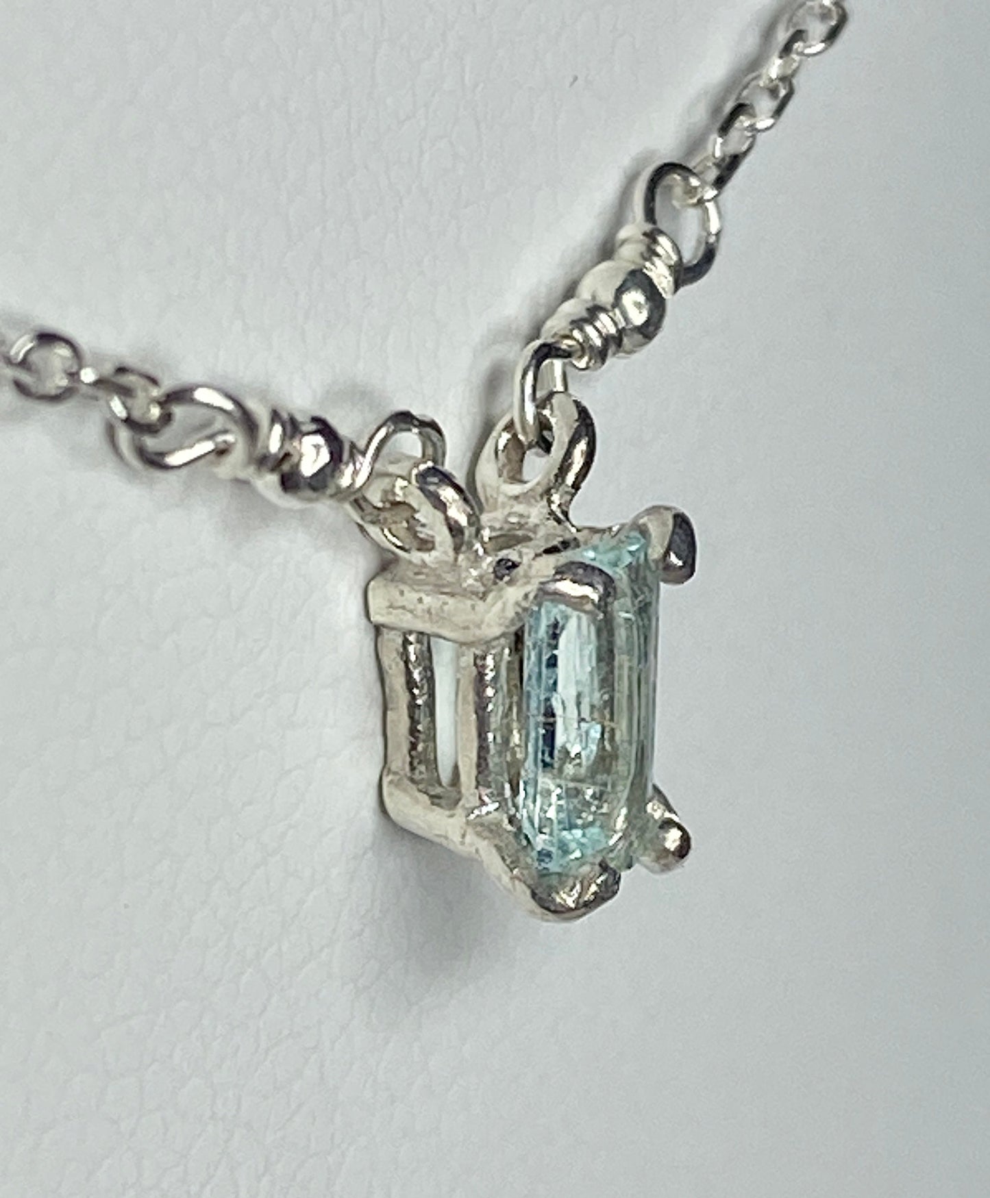 Sterling silver necklace with a rectangular cuprian tourmaline pendant.