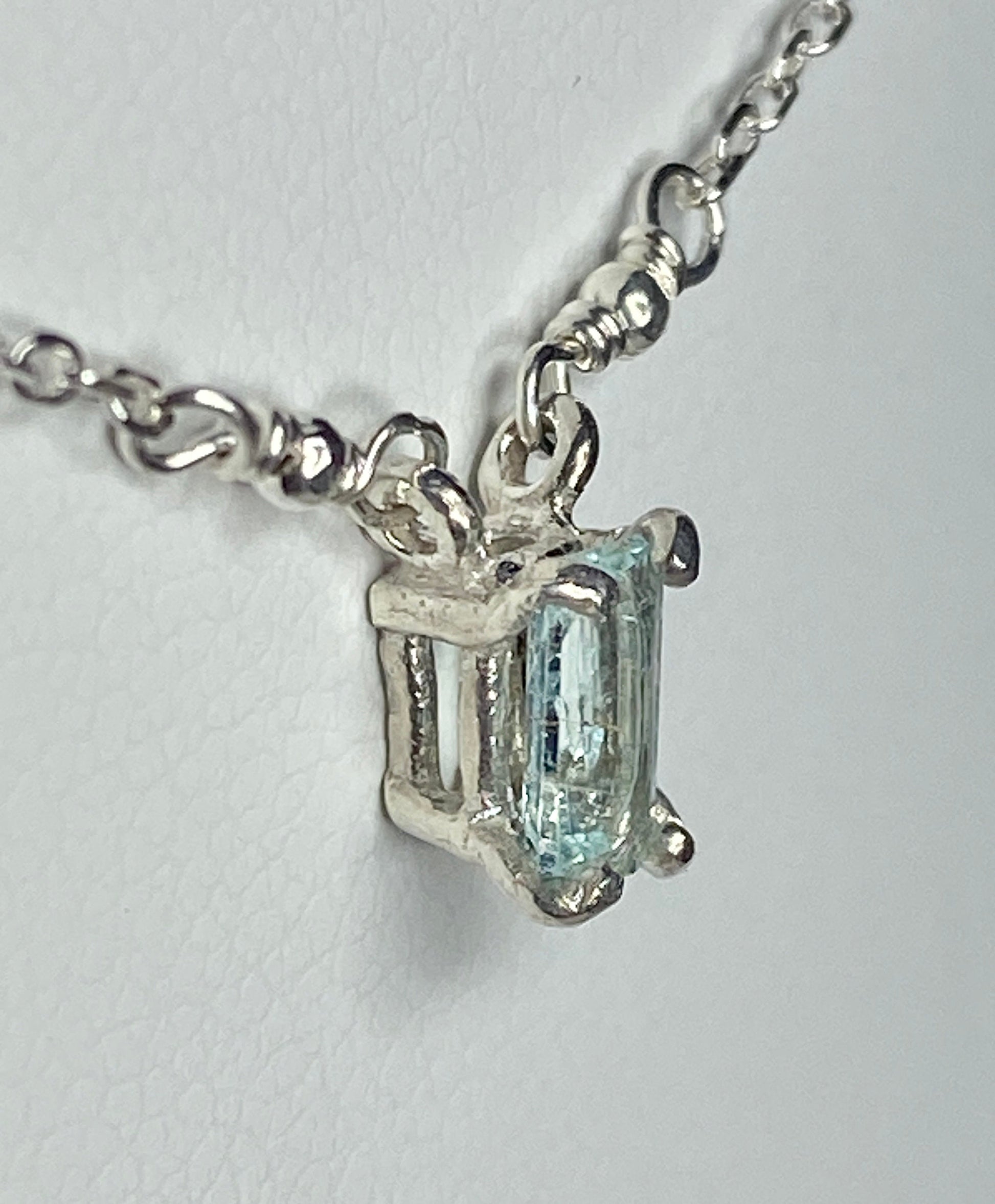 Sterling silver necklace with a rectangular cuprian tourmaline pendant.