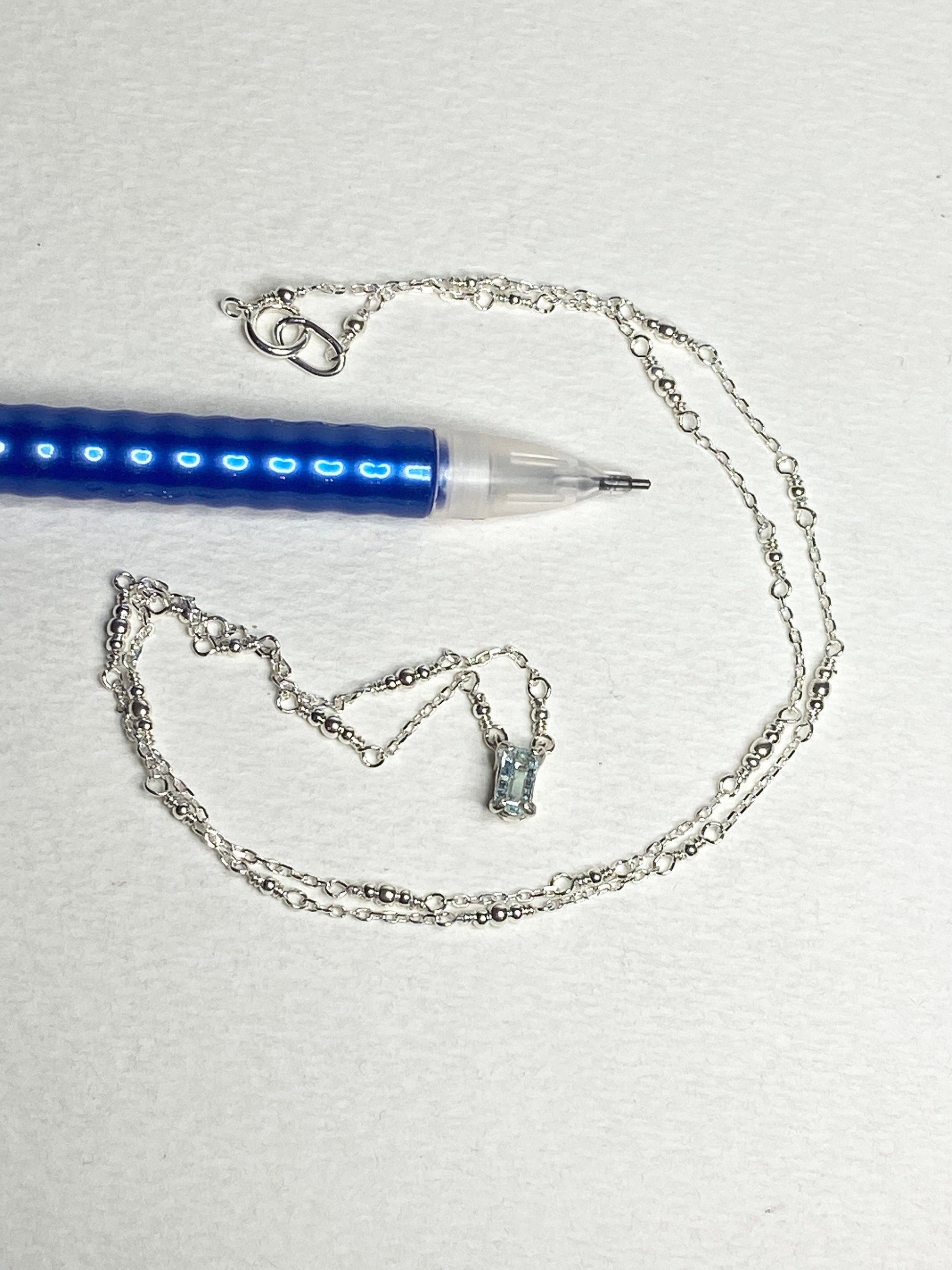 Sterling silver necklace with a rectangular cuprian tourmaline pendant.