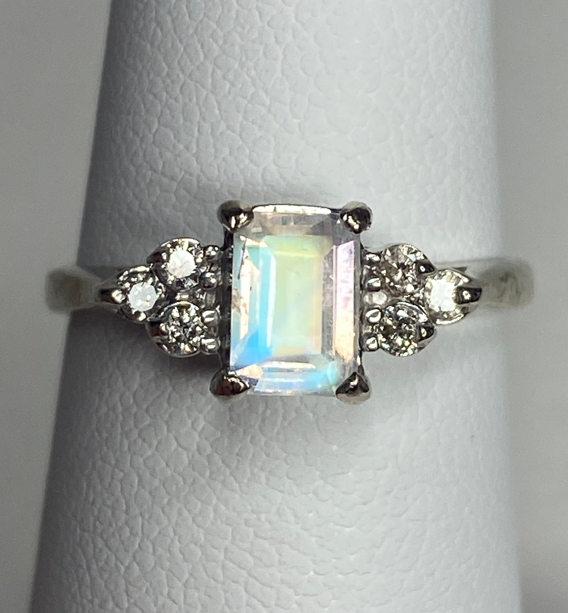 Emerald cut rainbow moonstone ring with diamonds in 14k white gold.