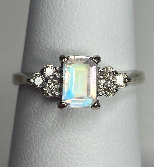 Emerald cut rainbow moonstone ring with diamonds in 14k white gold.
