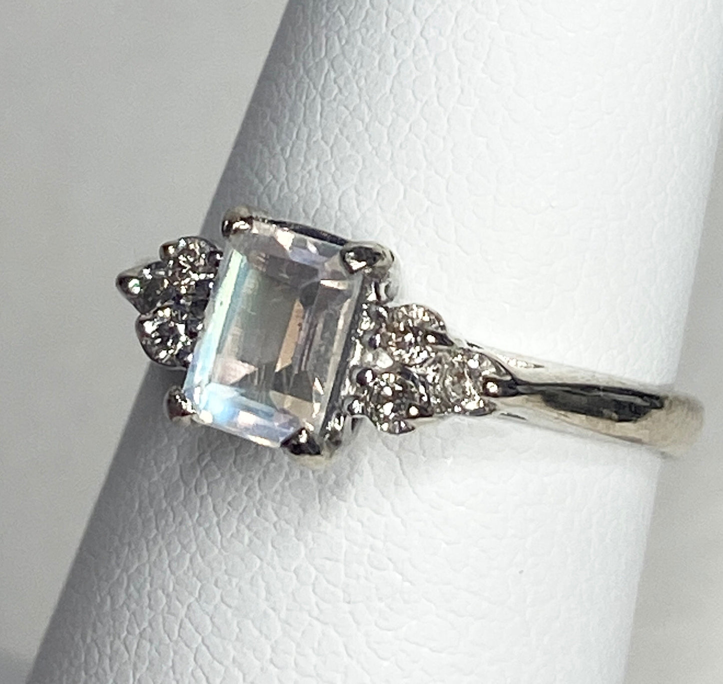 Emerald cut rainbow moonstone ring with diamonds in 14k white gold.
