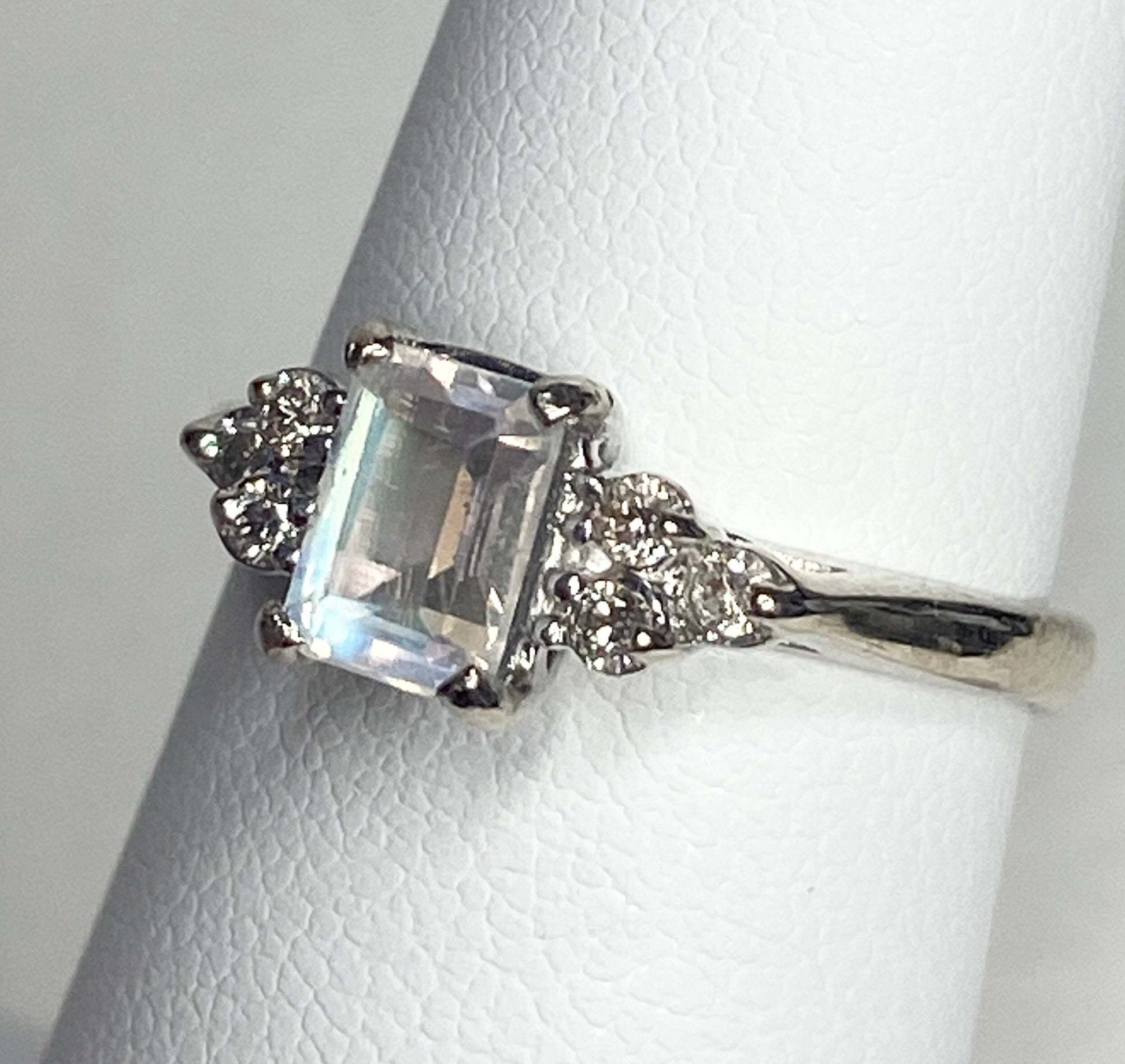 Emerald cut rainbow moonstone ring with diamonds in 14k white gold.
