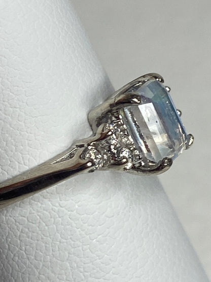 Emerald cut rainbow moonstone ring with diamonds in white gold.