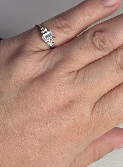 A 14k white gold ring with an emerald-cut rainbow moonstone and diamonds.