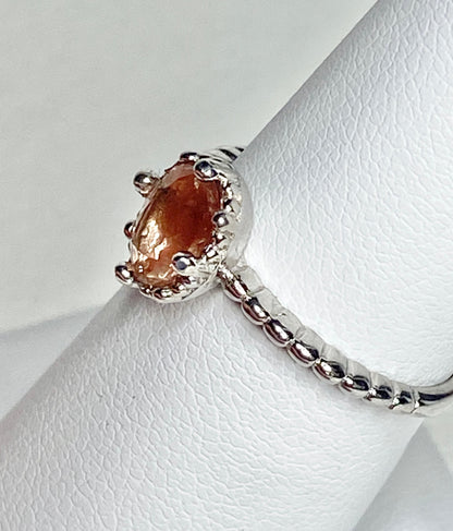 Sterling silver ring with a peach oval Oregon Sunstone and beaded band.