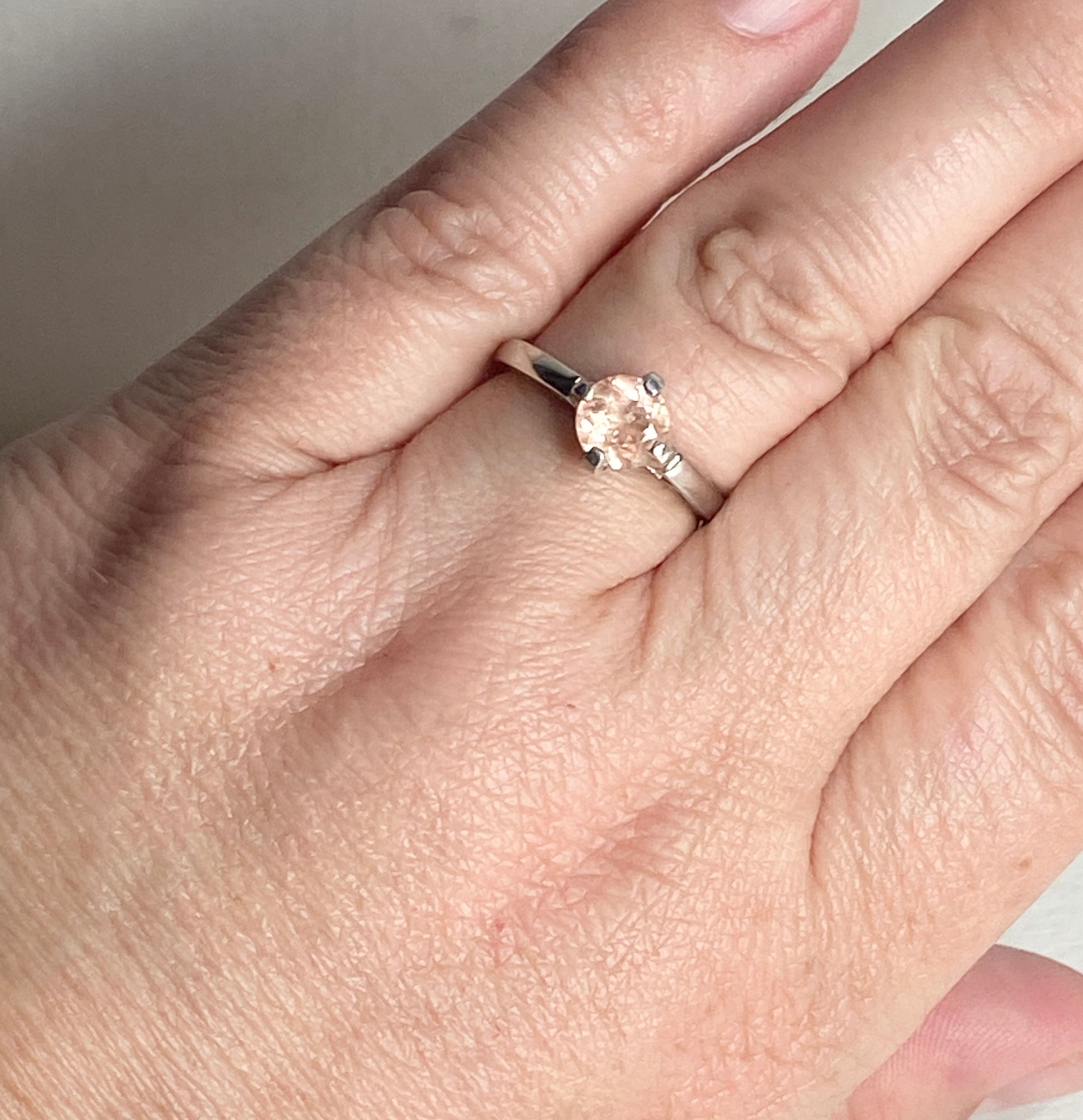 Sterling silver ring with a round, light peach Oregon sunstone.