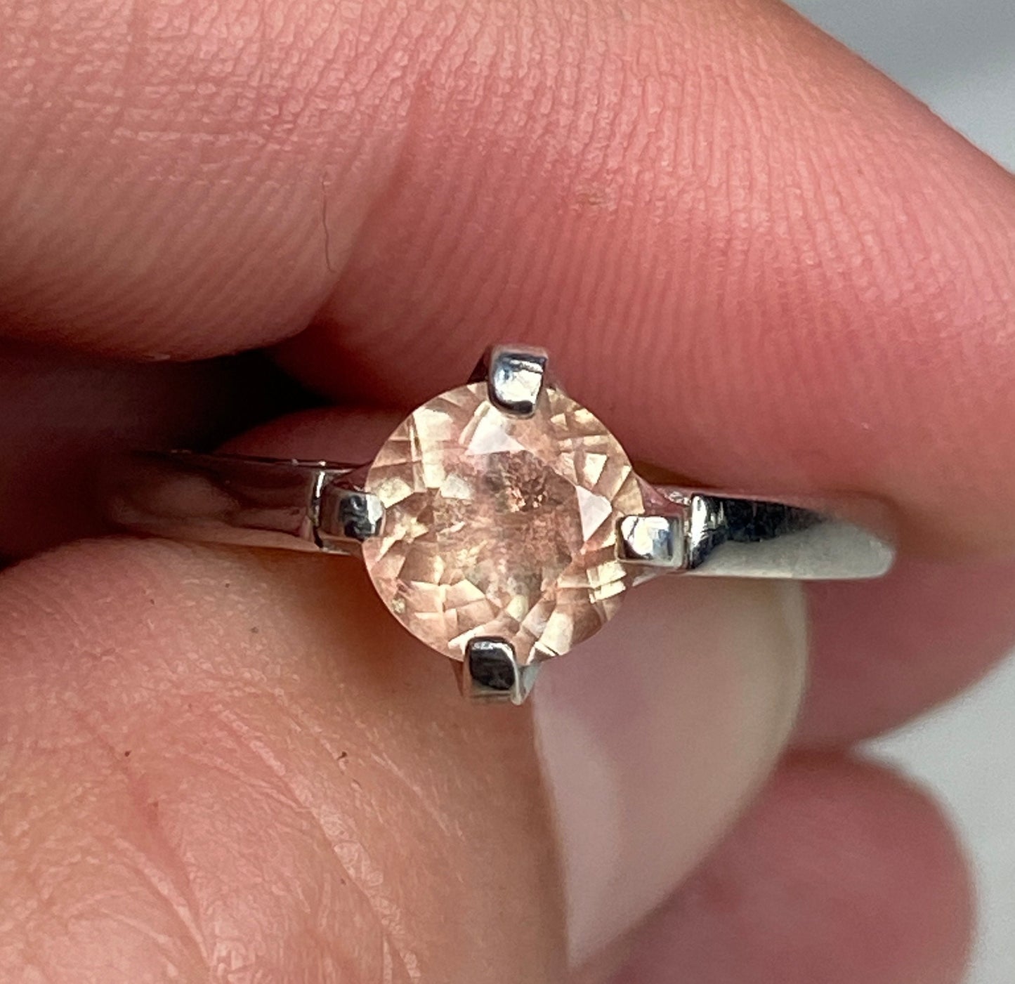 Sterling silver ring with a round, light peach Oregon sunstone.