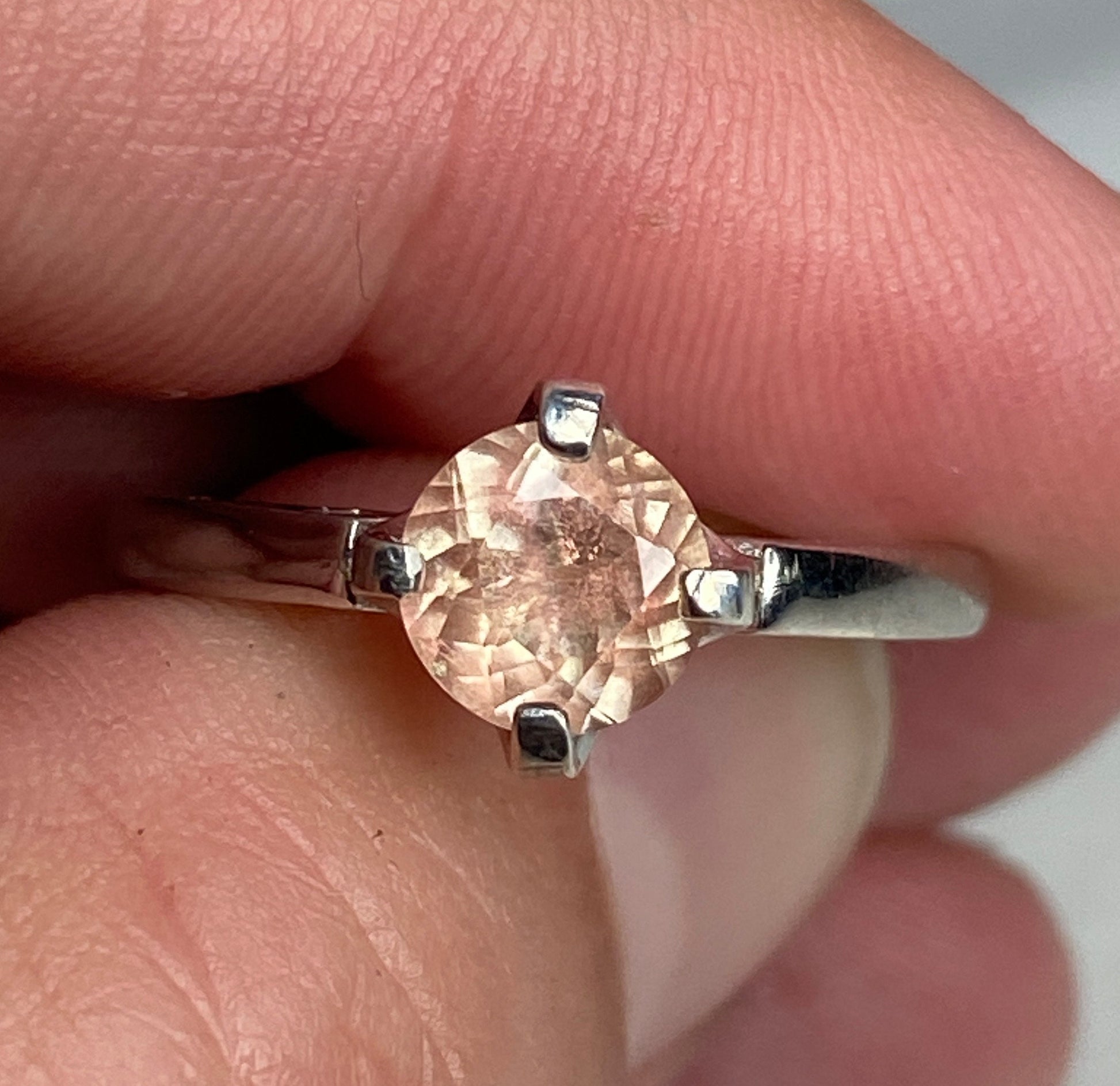 Sterling silver ring with a round, light peach Oregon sunstone.