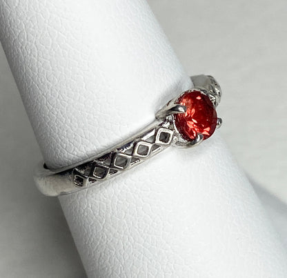 Sterling silver ring with a light red Oregon sunstone and diamond trellis design.