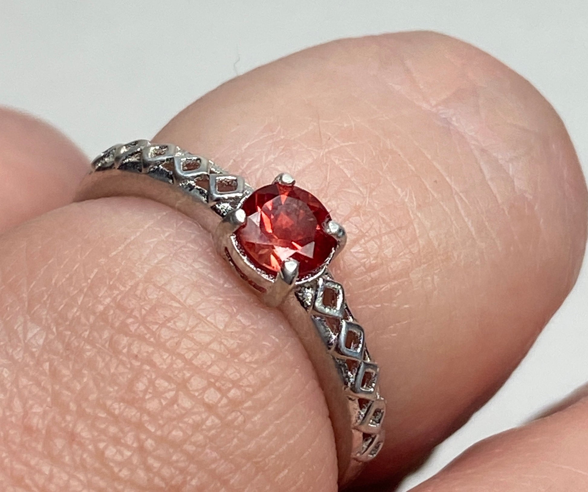 Sterling silver ring with a red Oregon sunstone and trellis design.