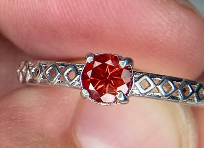 Sterling silver ring with a light red Oregon sunstone and diamond trellis design.