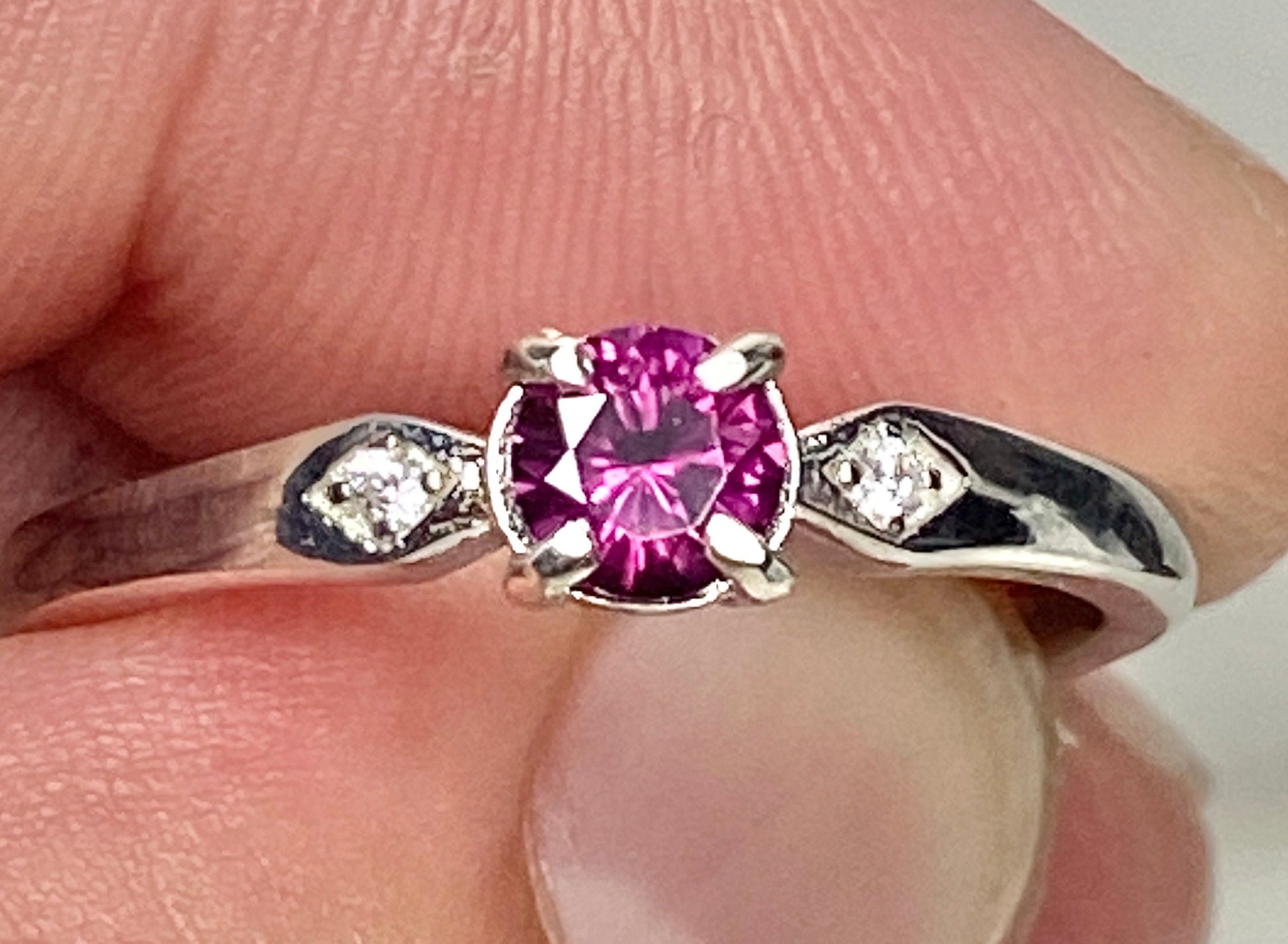 Idaho grape rhodolite garnet and sterling silver band ring with two small cz accents.