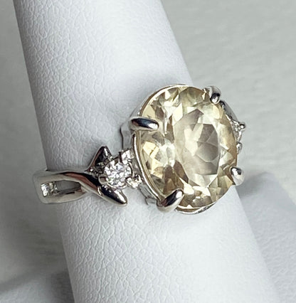 Sterling silver ring with oval Oregon sunstone and two diamonds.