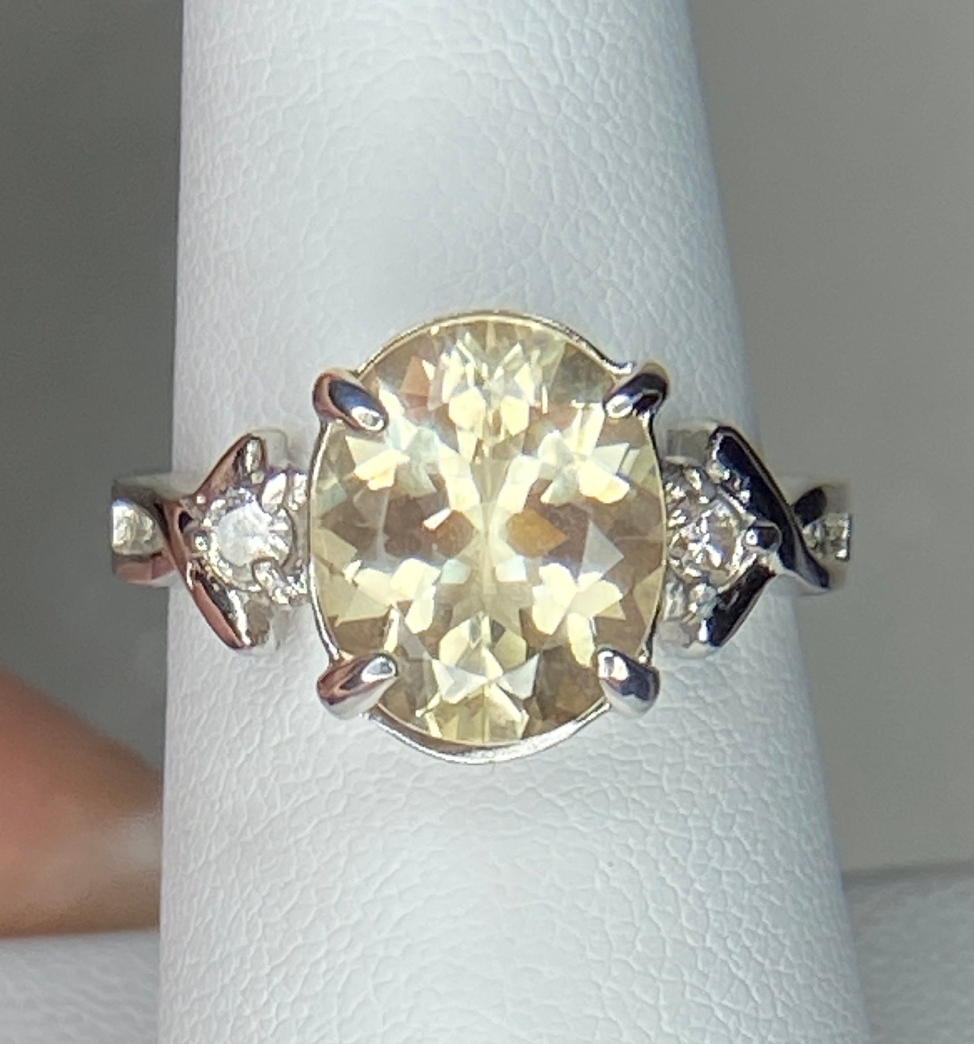 Sterling silver ring with oval Oregon sunstone and two diamonds.