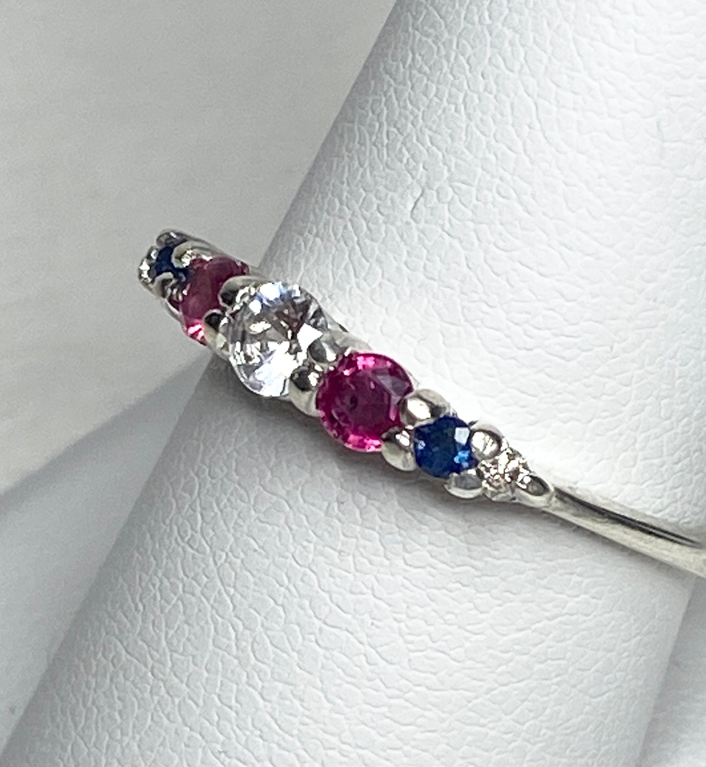 Sterling silver ring with sapphire, ruby, and diamond stones.
