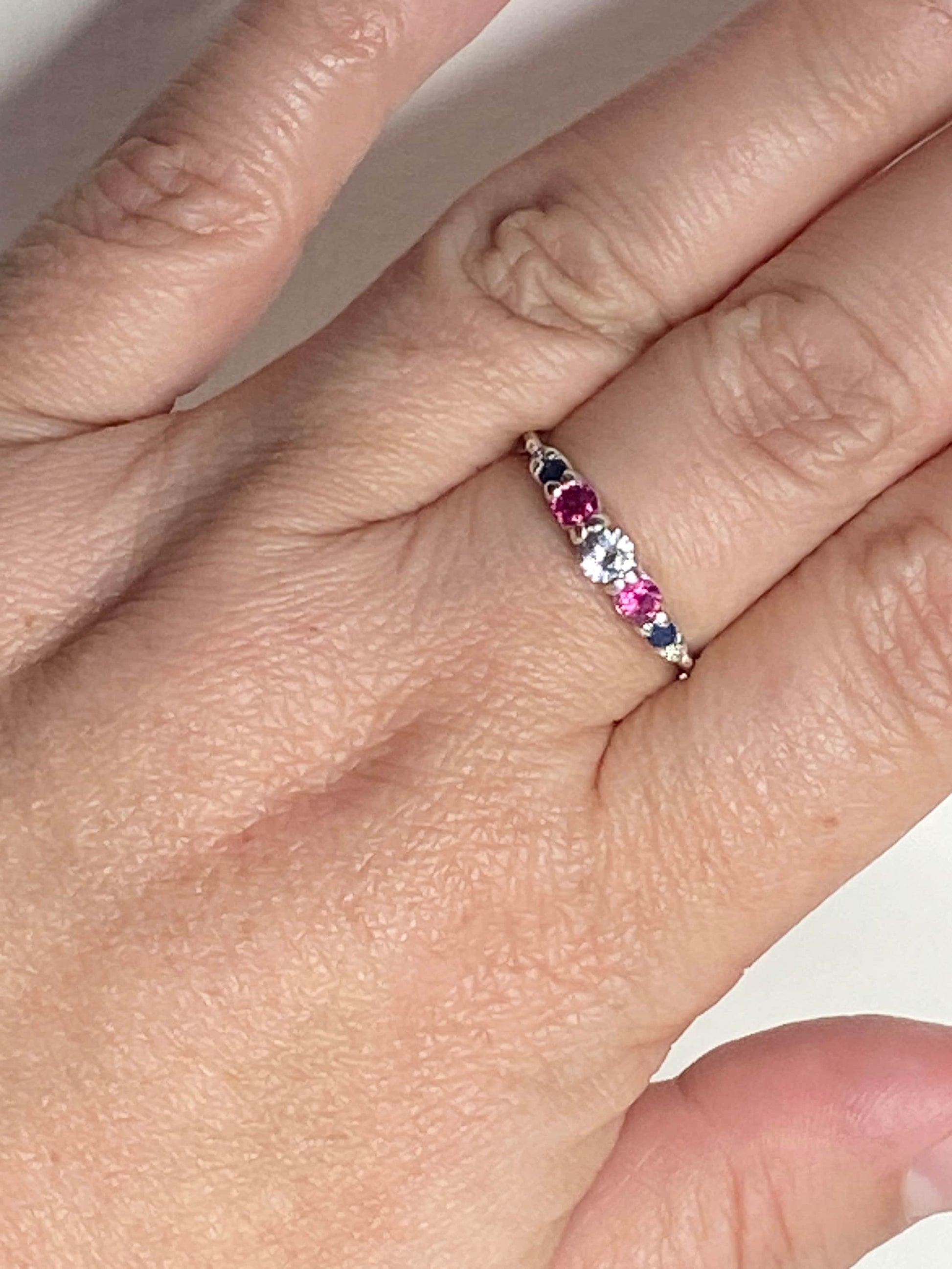 Sterling silver ring with sapphire, ruby, and diamond stones.