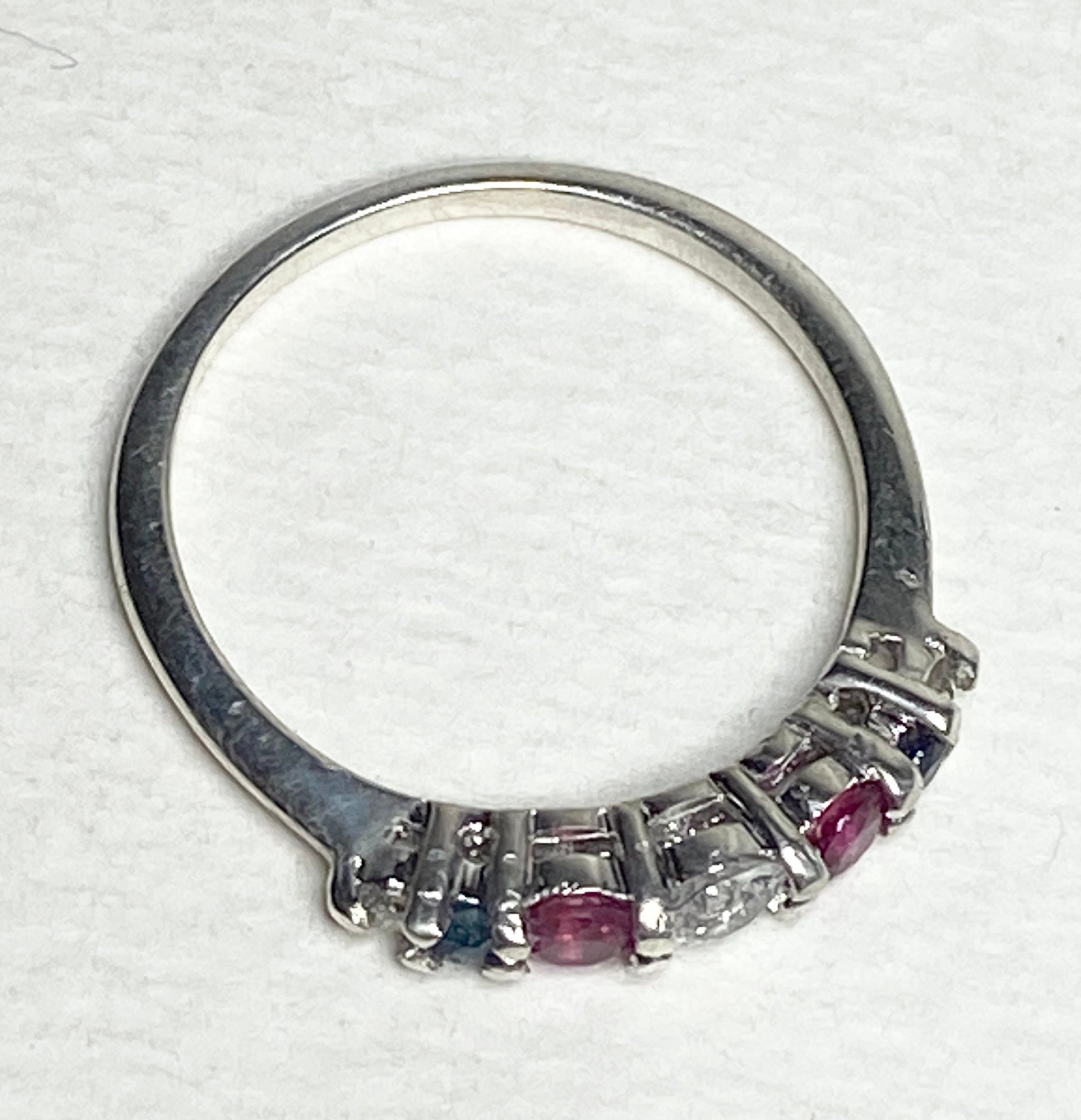 Sterling silver ring with sapphire, ruby, and diamond accents.