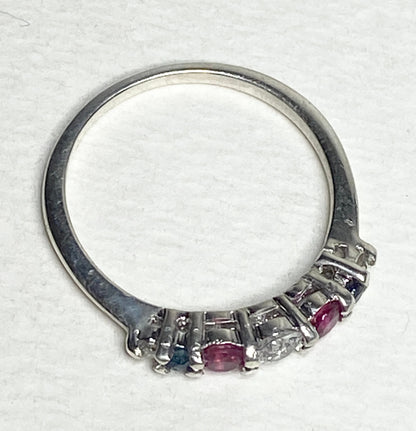 Sterling silver ring with sapphire, ruby, and diamond accents.