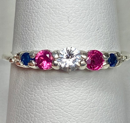 Sterling silver ring with a white sapphire, rubies, diamonds, and sapphires.