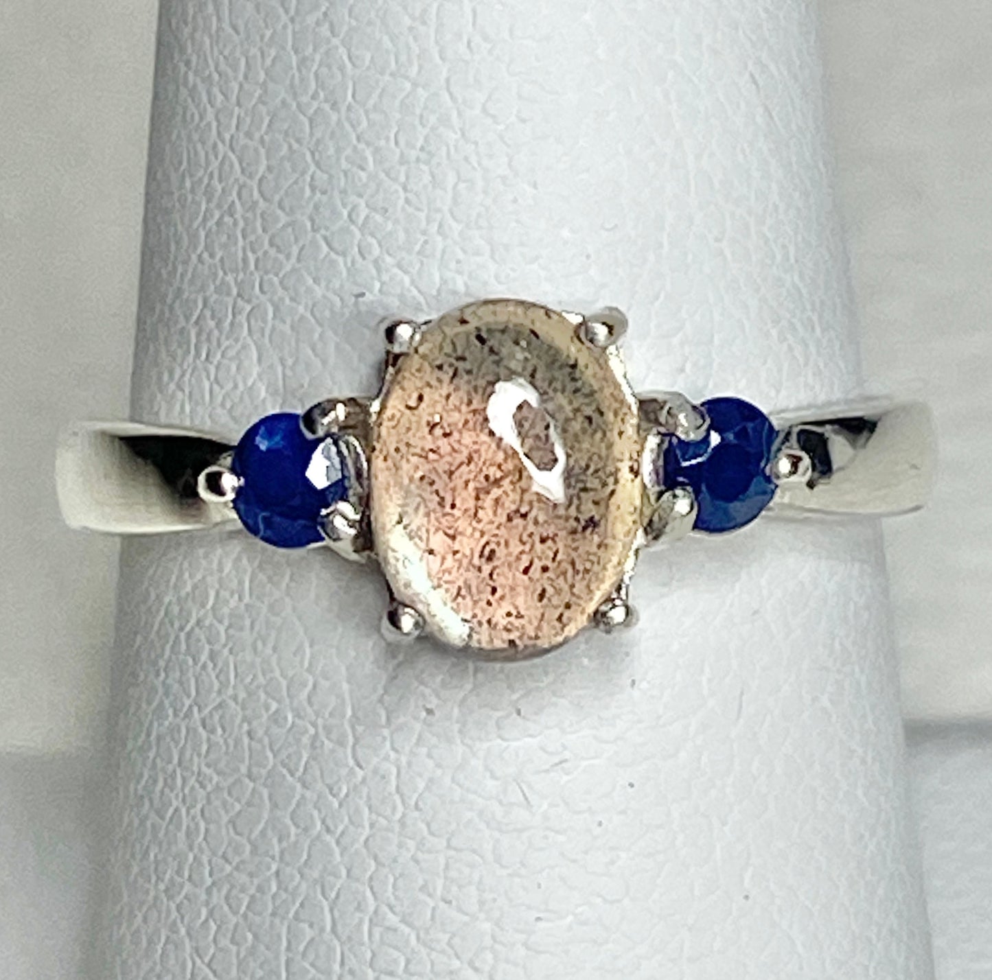 Sterling silver ring with oval labradorite and two round sapphires.