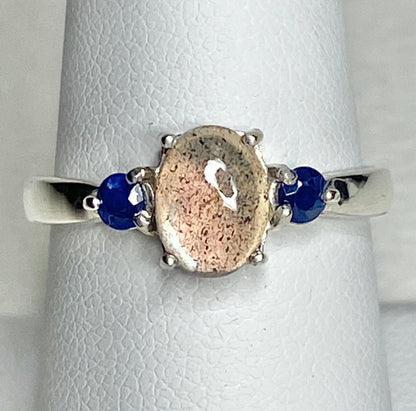 Sterling silver ring with oval labradorite and two round sapphires.