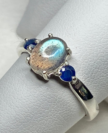 Sterling silver ring with oval labradorite and two blue sapphires.