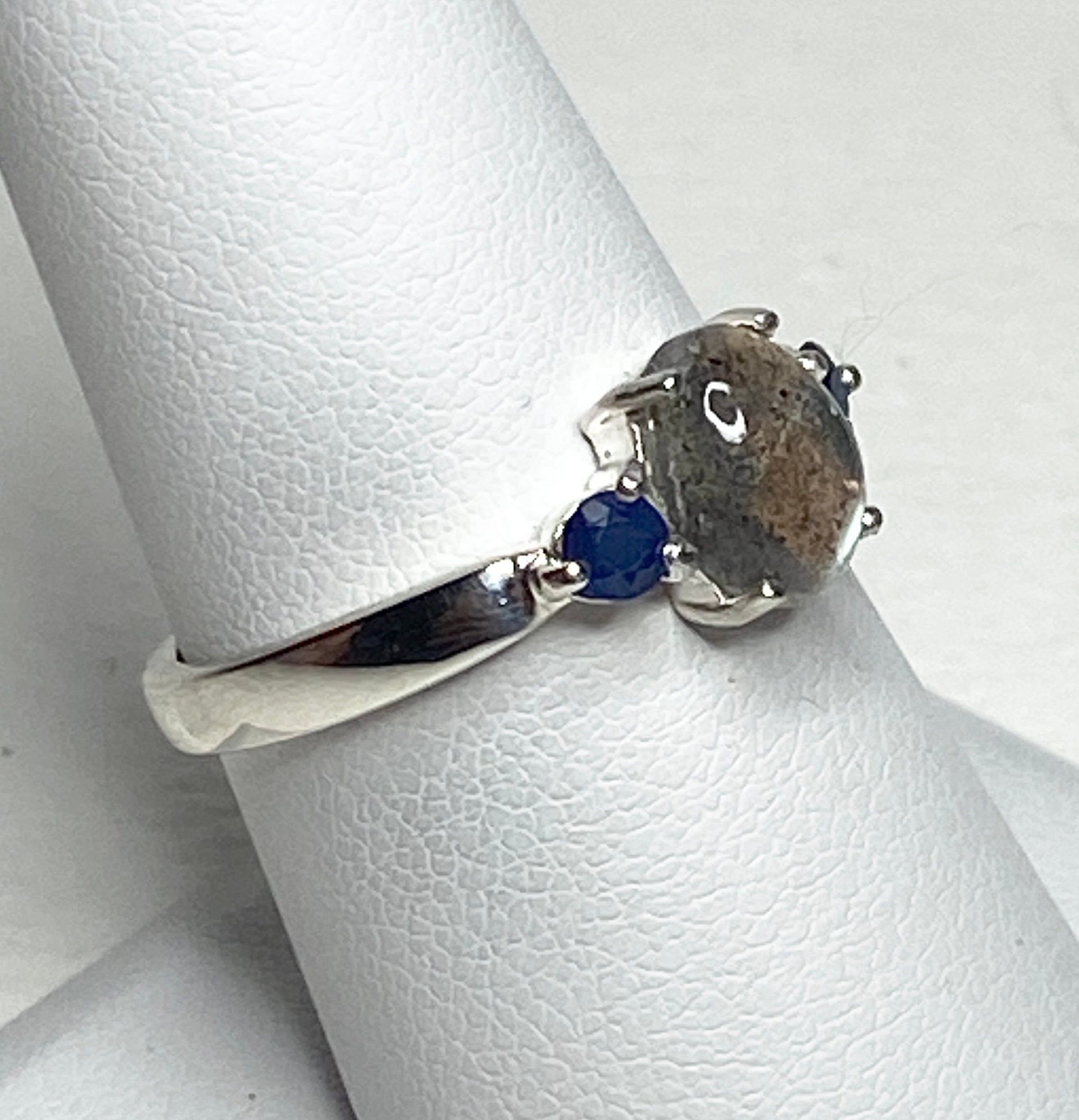 Sterling silver ring with oval labradorite and two blue sapphires.